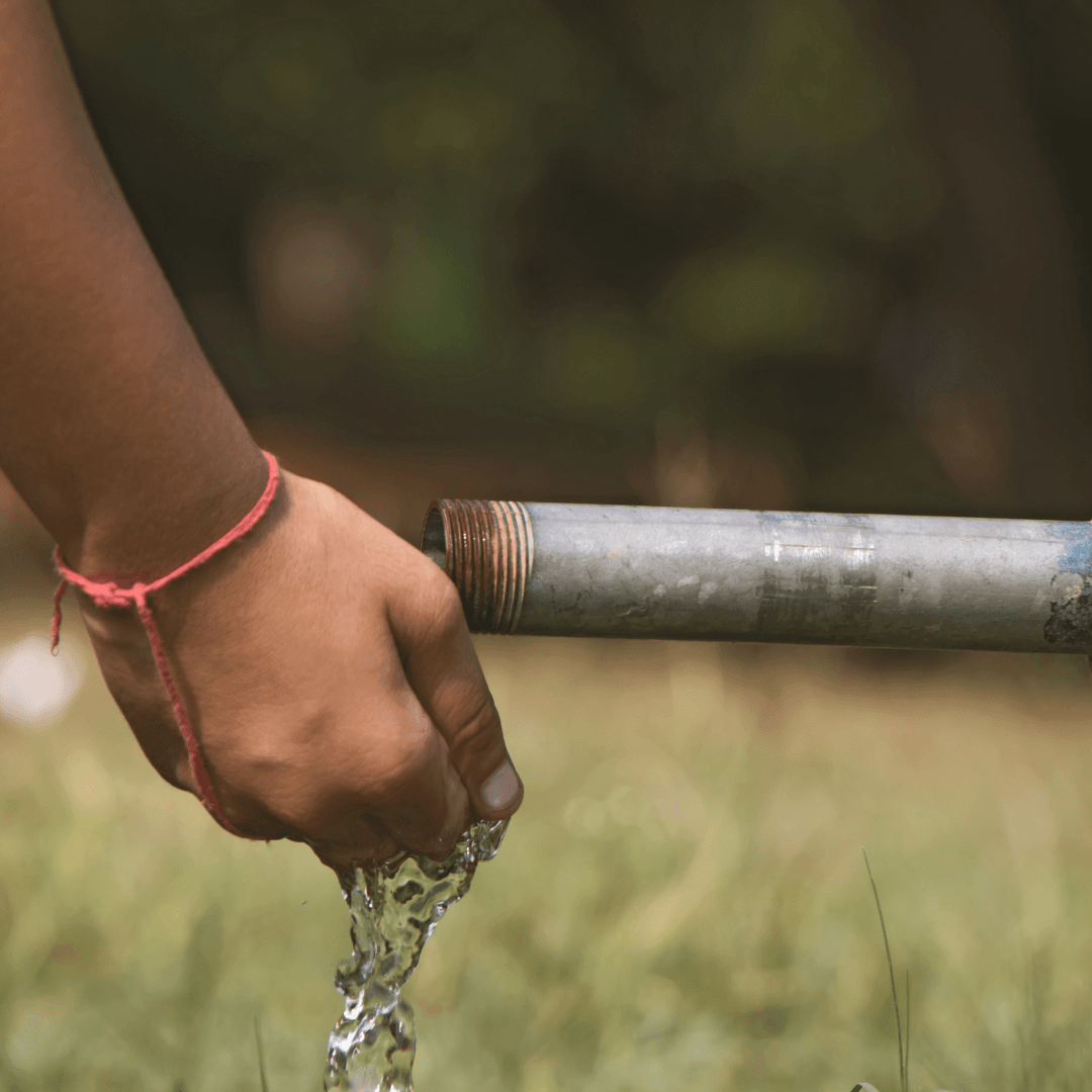 Water coming from pipe into hands